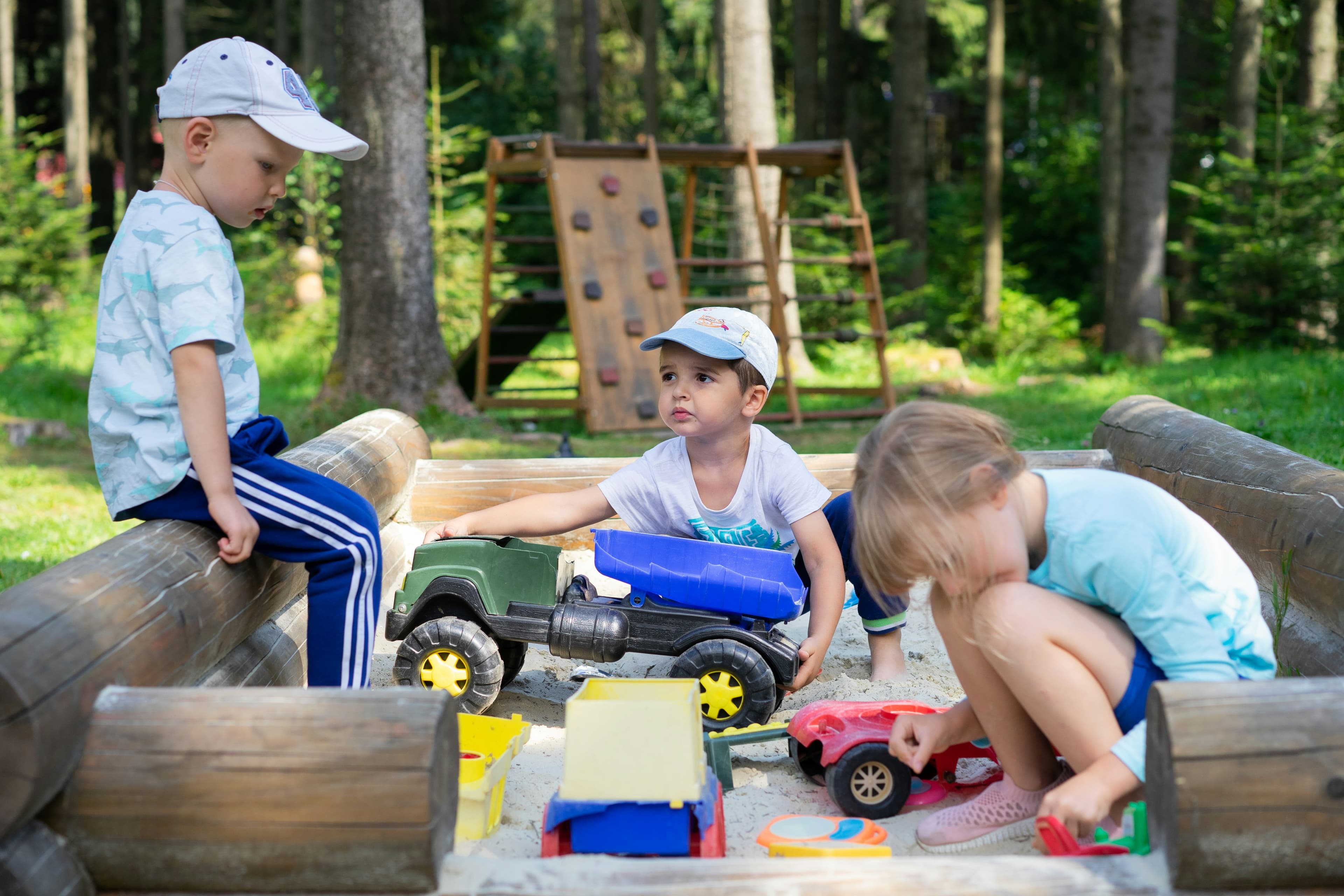 Children playing together in a sandbox outdoors